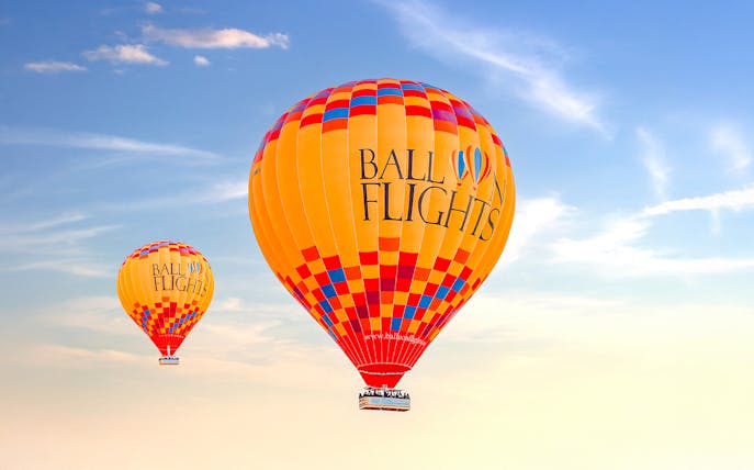 Hot air balloons in flight against a clear sky, promoting a limited time offer for two.