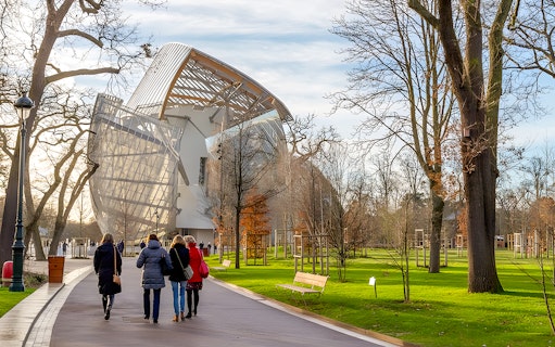 Visitors walking towards the Foundation Louis Vuitton building in Paris.