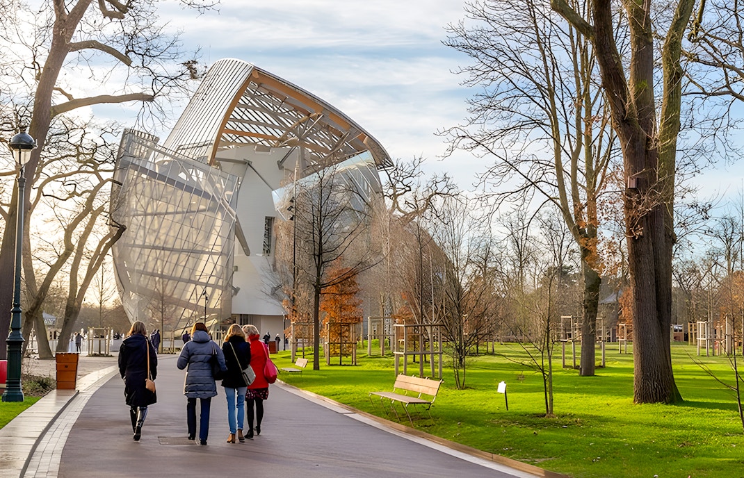 Visitors walking towards the Foundation Louis Vuitton building in Paris.
