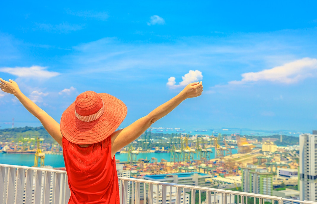 Person enjoying panoramic view of Sentosa Island attractions, Singapore.