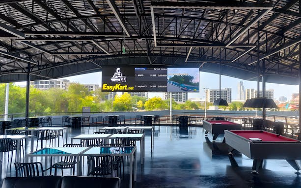 Cafeteria area with tables and pool tables at outdoor go-karting venue in Thepprasit Pattaya.