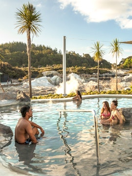 Visitors relaxing in geothermal pool at Hell's Gate Geothermal Reserve, New Zealand.