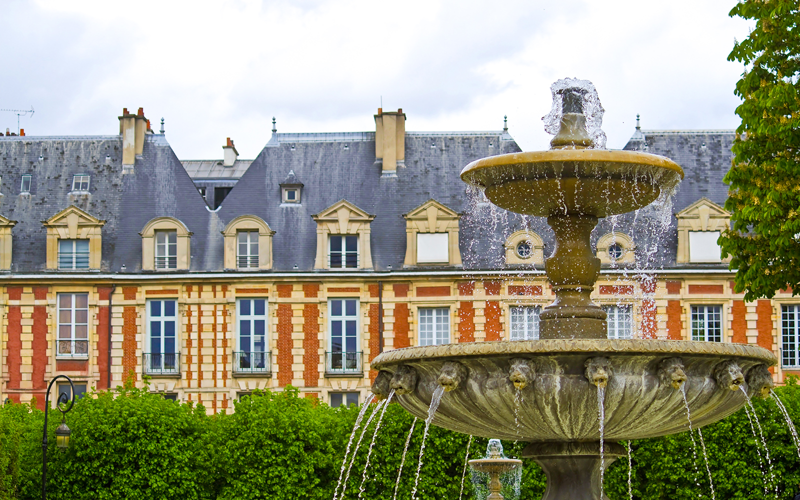 Fountain in front of The Victor Hugo House exterior in Paris.