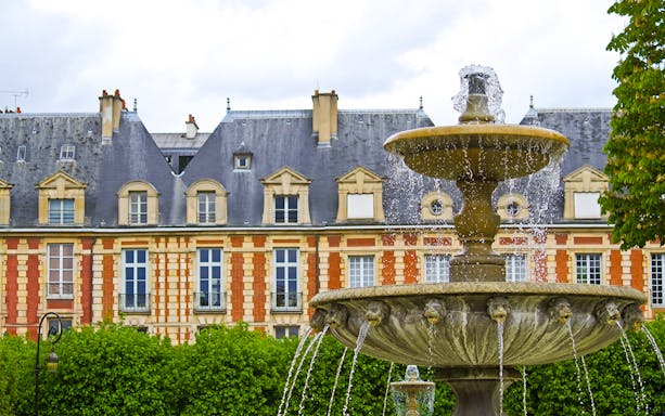 Fountain in front of The Victor Hugo House exterior in Paris.