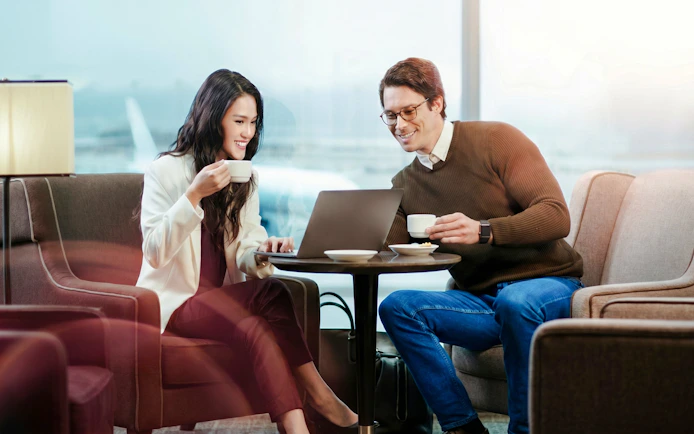 Couple enjoying coffee in VIP Lounge by MERA Roof, Terminal 3, Cancún International Airport.