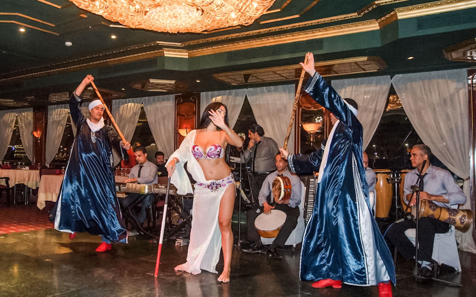 Dancer performing with musicians on a luxury Nile dinner cruise.