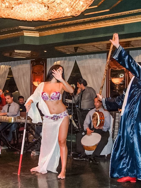 Dancer performing with musicians on a luxury Nile dinner cruise.