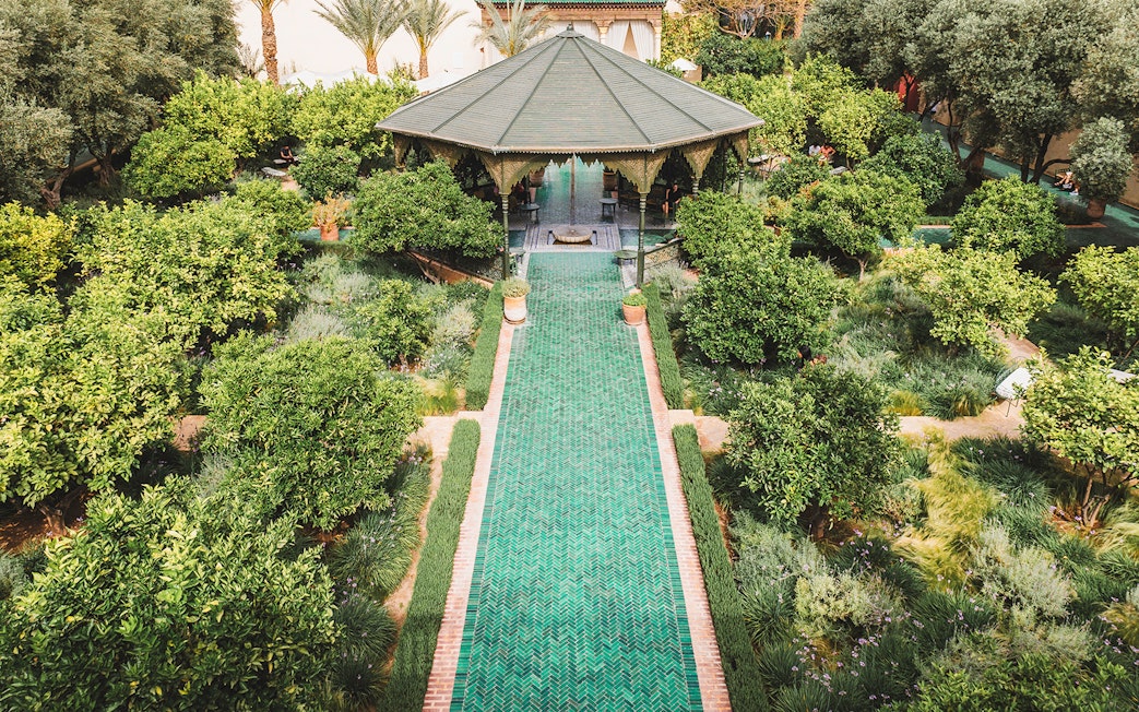 Jardin Secret pavilion surrounded by lush greenery in Marrakech, Morocco.