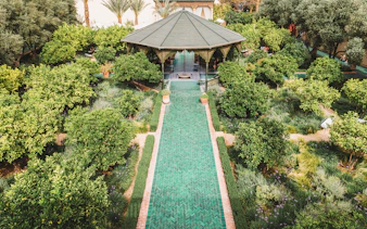Jardin Secret pavilion surrounded by lush greenery in Marrakech, Morocco.