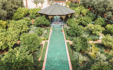 Jardin Secret pavilion surrounded by lush greenery in Marrakech, Morocco.