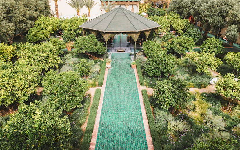 Jardin Secret pavilion surrounded by lush greenery in Marrakech, Morocco.