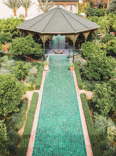 Jardin Secret pavilion surrounded by lush greenery in Marrakech, Morocco.