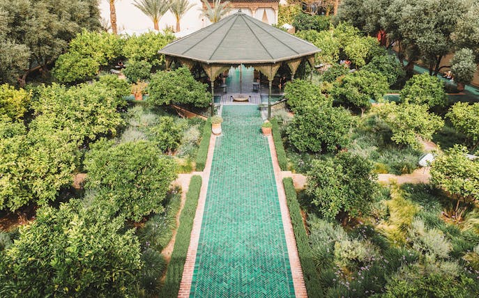 Jardin Secret pavilion surrounded by lush greenery in Marrakech, Morocco.