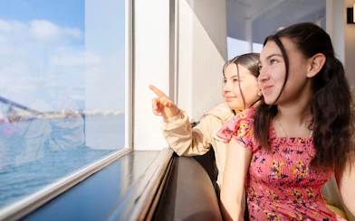 Kids looking out the window on San Diego brunch cruise.