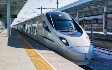 Shinkansen train at a station platform in Japan.