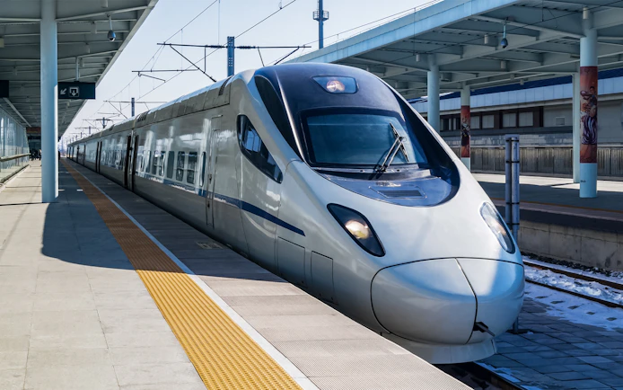 Shinkansen train at a station platform in Japan.