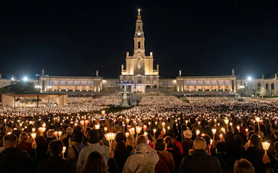 Candlelight procession at Fatima Sanctuary during night pilgrimage tour.