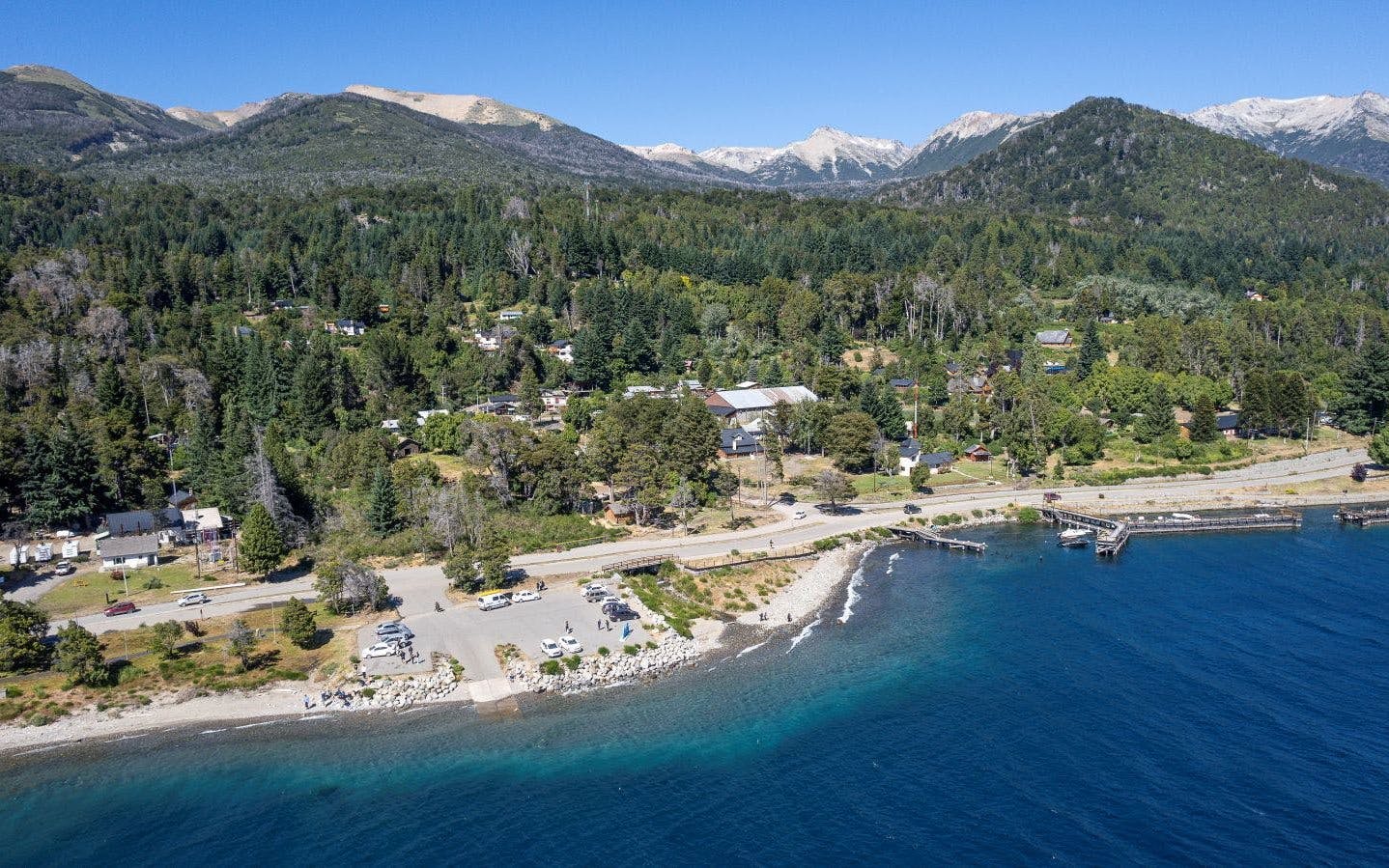 Aerial view of Villa La Angostura with Nahuel Huapi Lake shoreline and forested hills.
