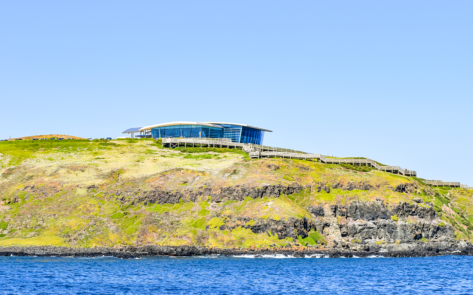 Phillip Island visitor center on a cliff overlooking the ocean, seen from the Seal Watching Afternoon Cruise.