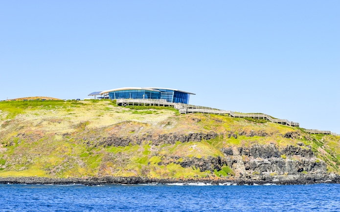 Phillip Island visitor center on a cliff overlooking the ocean, seen from the Seal Watching Afternoon Cruise.