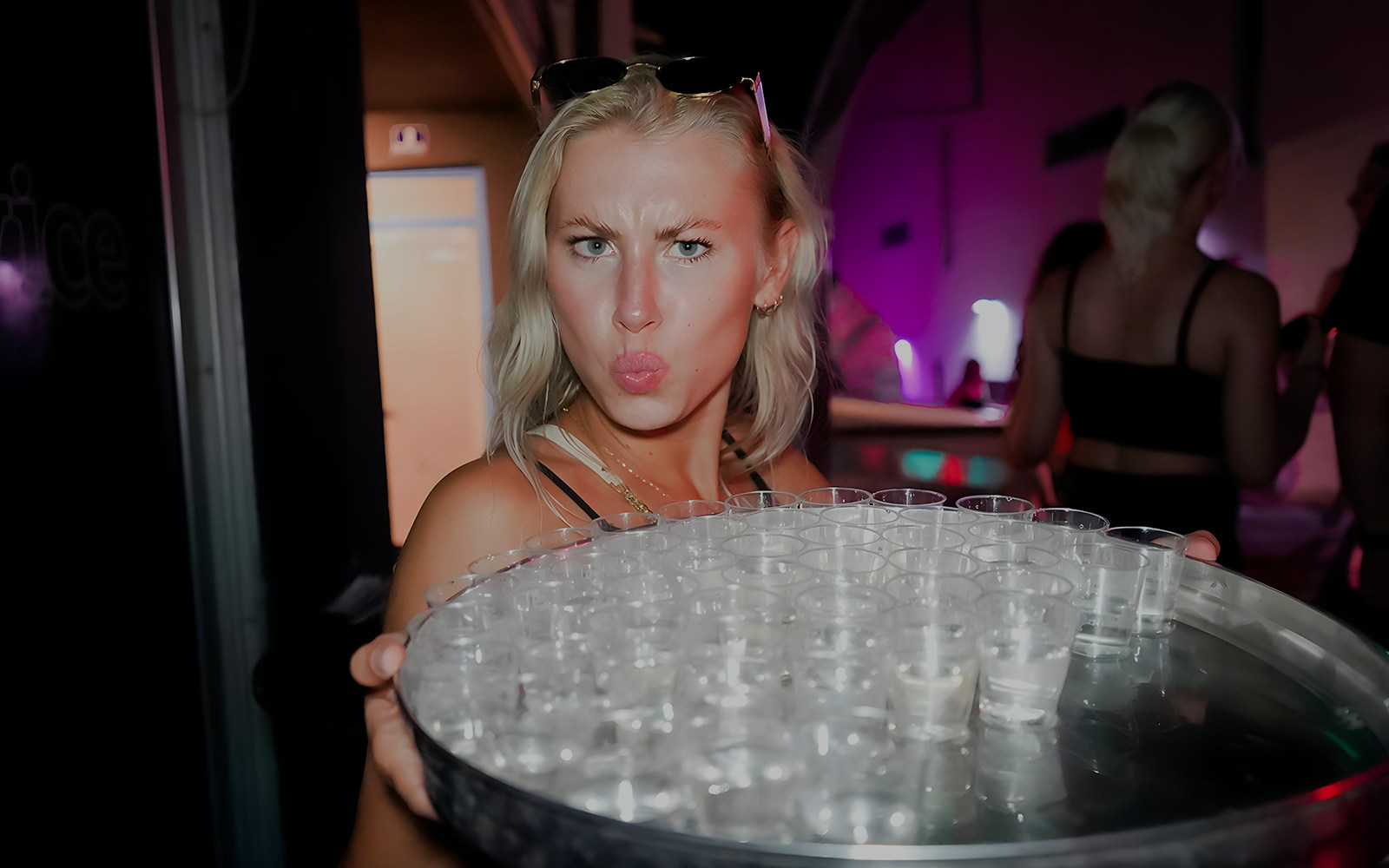 Person holding a tray of shot glasses during a boat crawl in Split.