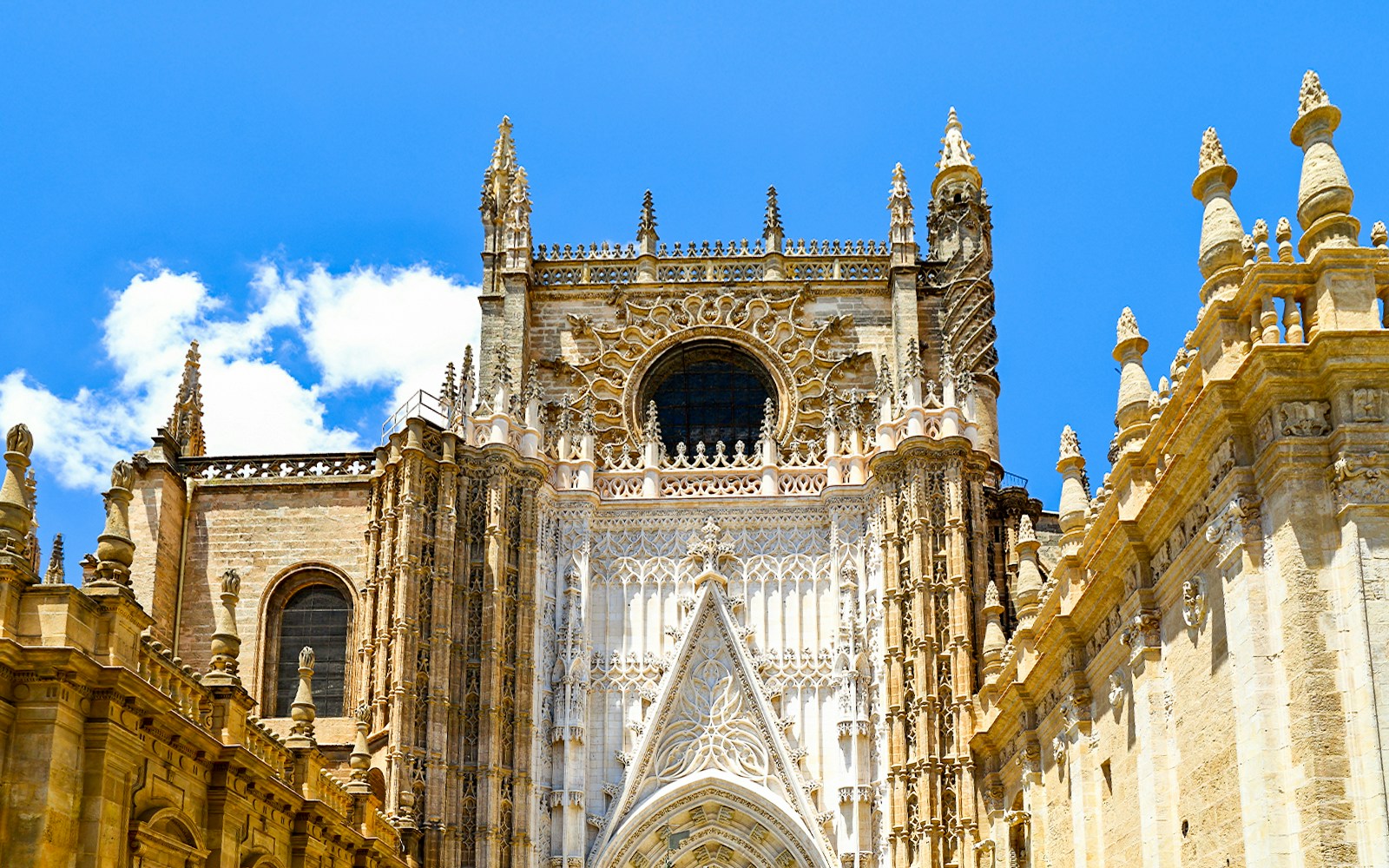 Seville Cathedral facade with intricate Gothic architecture, Spain.