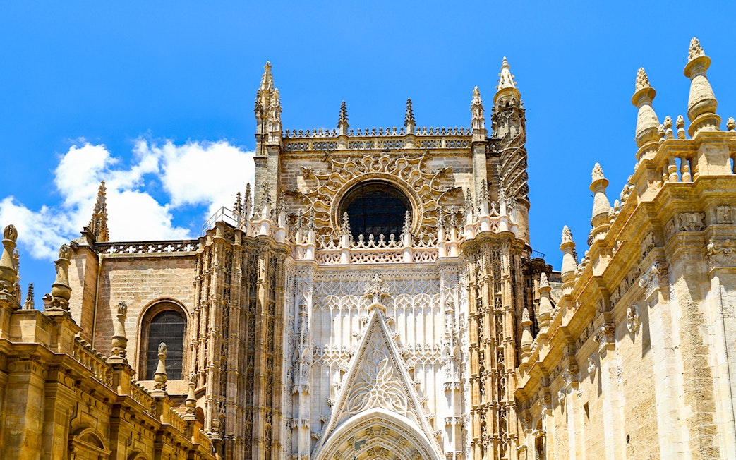 Seville Cathedral facade with intricate Gothic architecture.