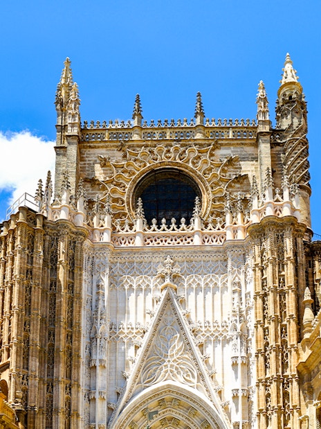 Seville Cathedral facade with intricate Gothic architecture.