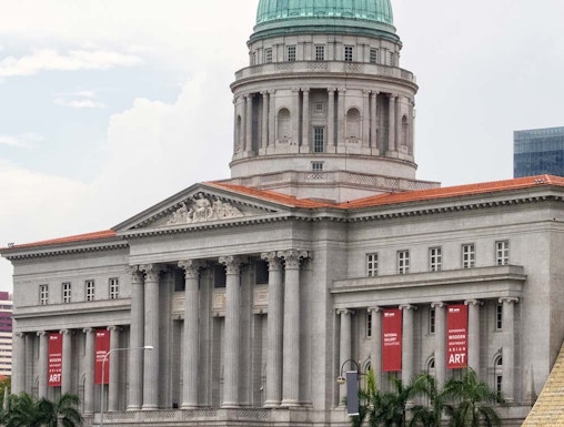 National Gallery Singapore with dome and columns, banners for modern art exhibition.