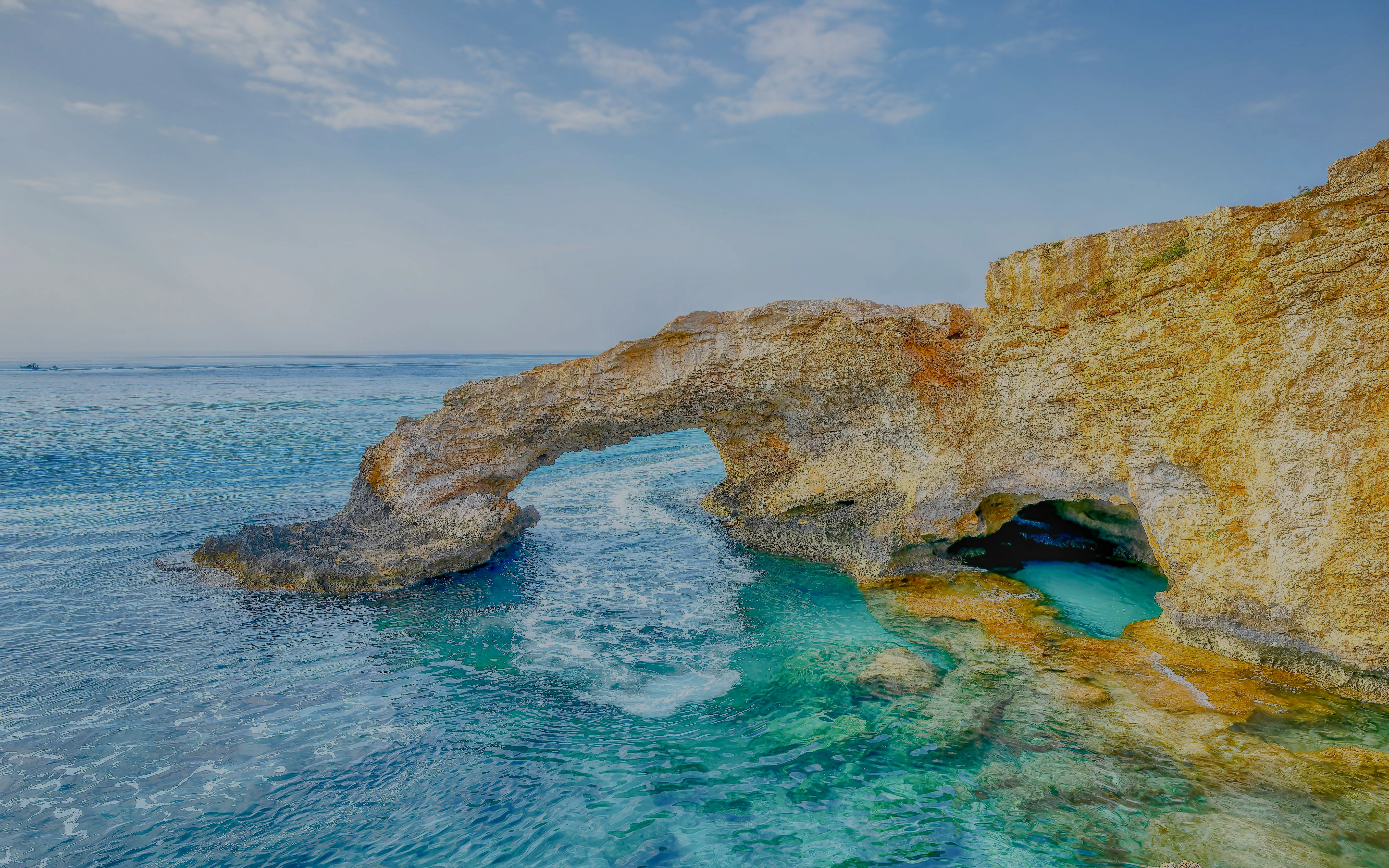 Bridge of Lovers rock formation over turquoise sea in Agia Napa, Cyprus.
