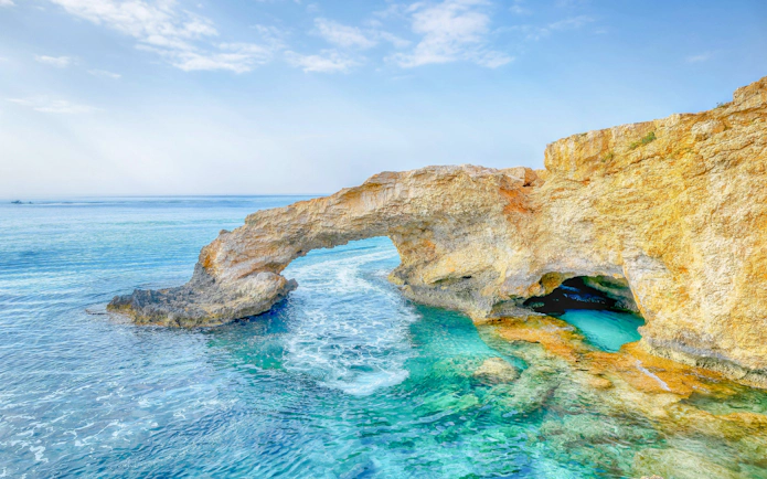 Bridge of Lovers rock formation over turquoise sea in Agia Napa, Cyprus.