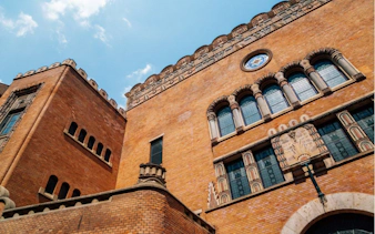 Historic building facade in Budapest's Jewish Quarter with ornate windows and brickwork.