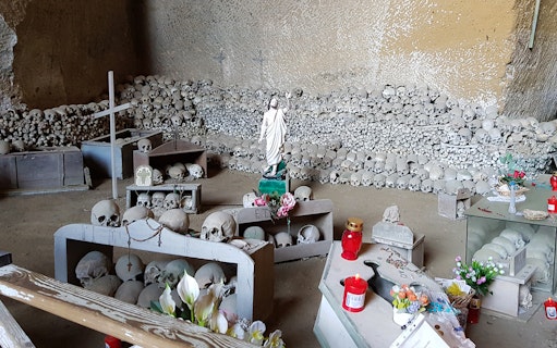 Skulls and religious artifacts at Fontanelle Cemetery, Naples, on the Rione Sanità walking tour.
