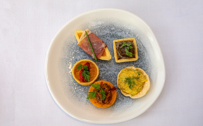 Assorted appetizers on a plate served during the London Dinner Cruise.