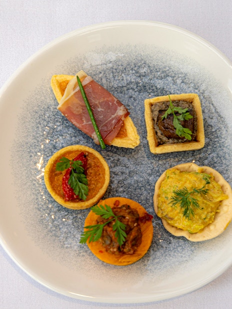Assorted appetizers on a plate served during the London Dinner Cruise.