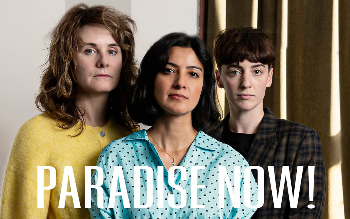 Three people standing together with the text "Paradise Now!" in front.