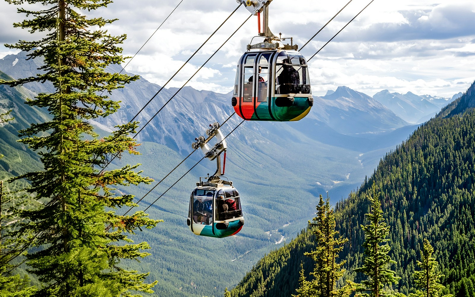 Gondola cable cars ascending Sulphur Mountain in Banff National Park, Canadian Rockies.
