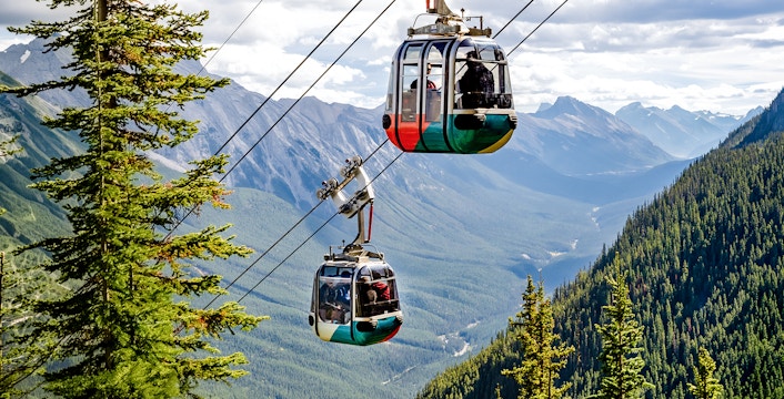 Gondola cable cars ascending Sulphur Mountain in Banff National Park, Canadian Rockies.