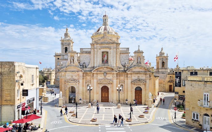 Mdina Cathedral facade with people walking, part of 2.5-hour guided tour of Mdina and Rabat.