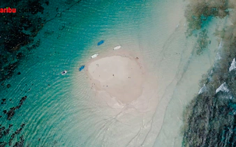 Glass-bottom boats near Robinson Island, Diani Beach, surrounded by turquoise water.