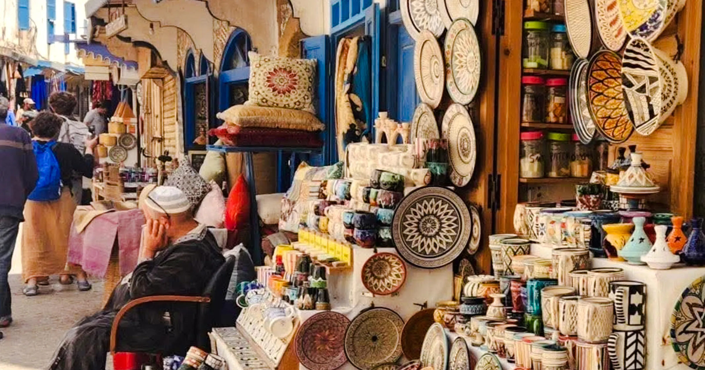 Essaouira market stall with colorful ceramics and textiles on Safi Coast Discovery Walk.
