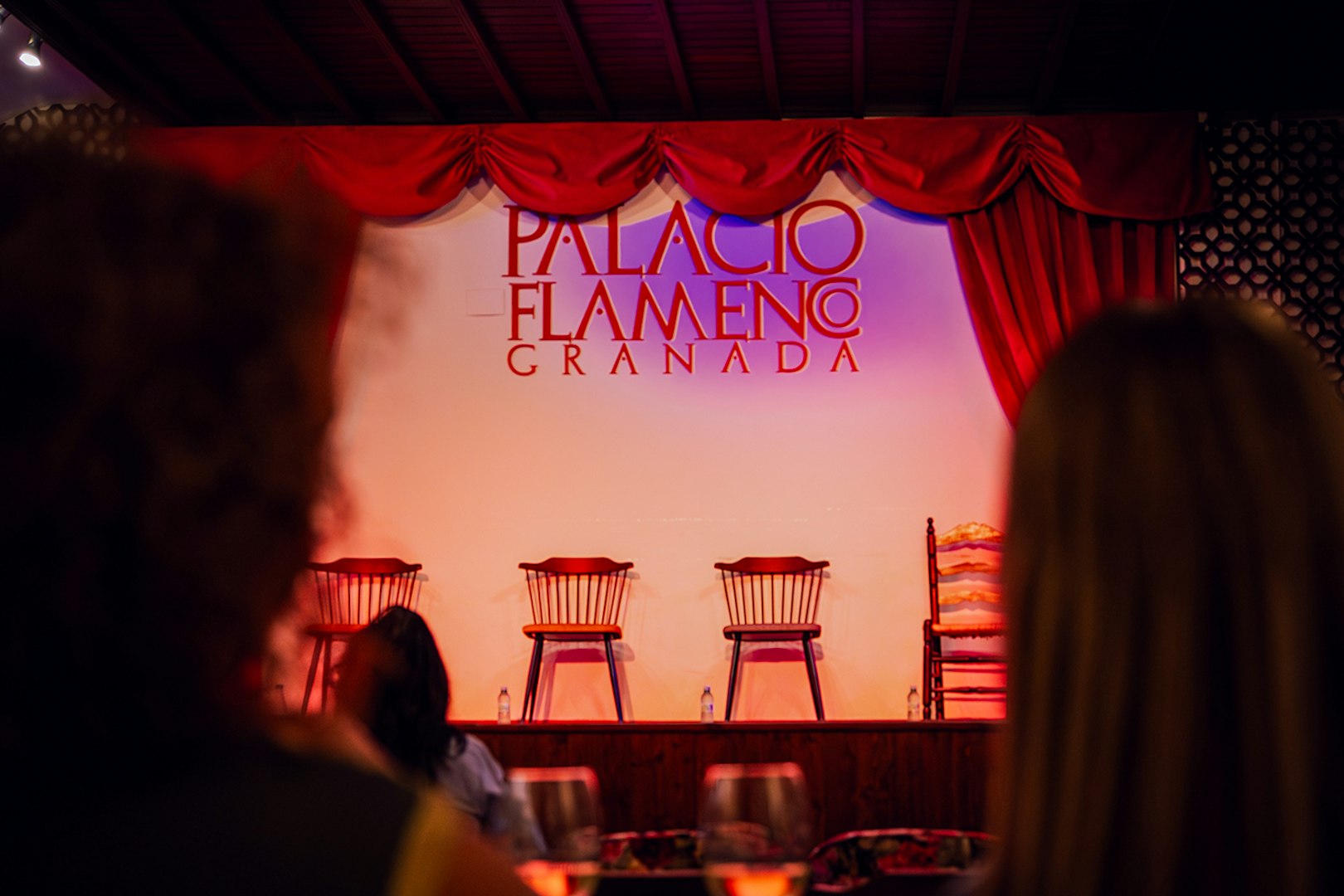 Palacio Flamenco Granada stage with empty chairs before a flamenco show.