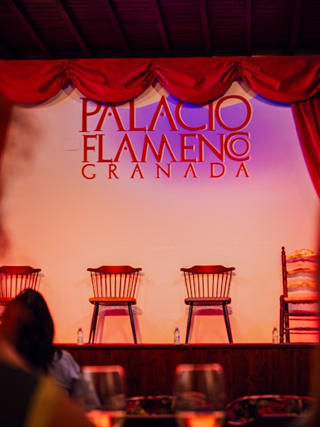Palacio Flamenco Granada stage with empty chairs before a flamenco show.