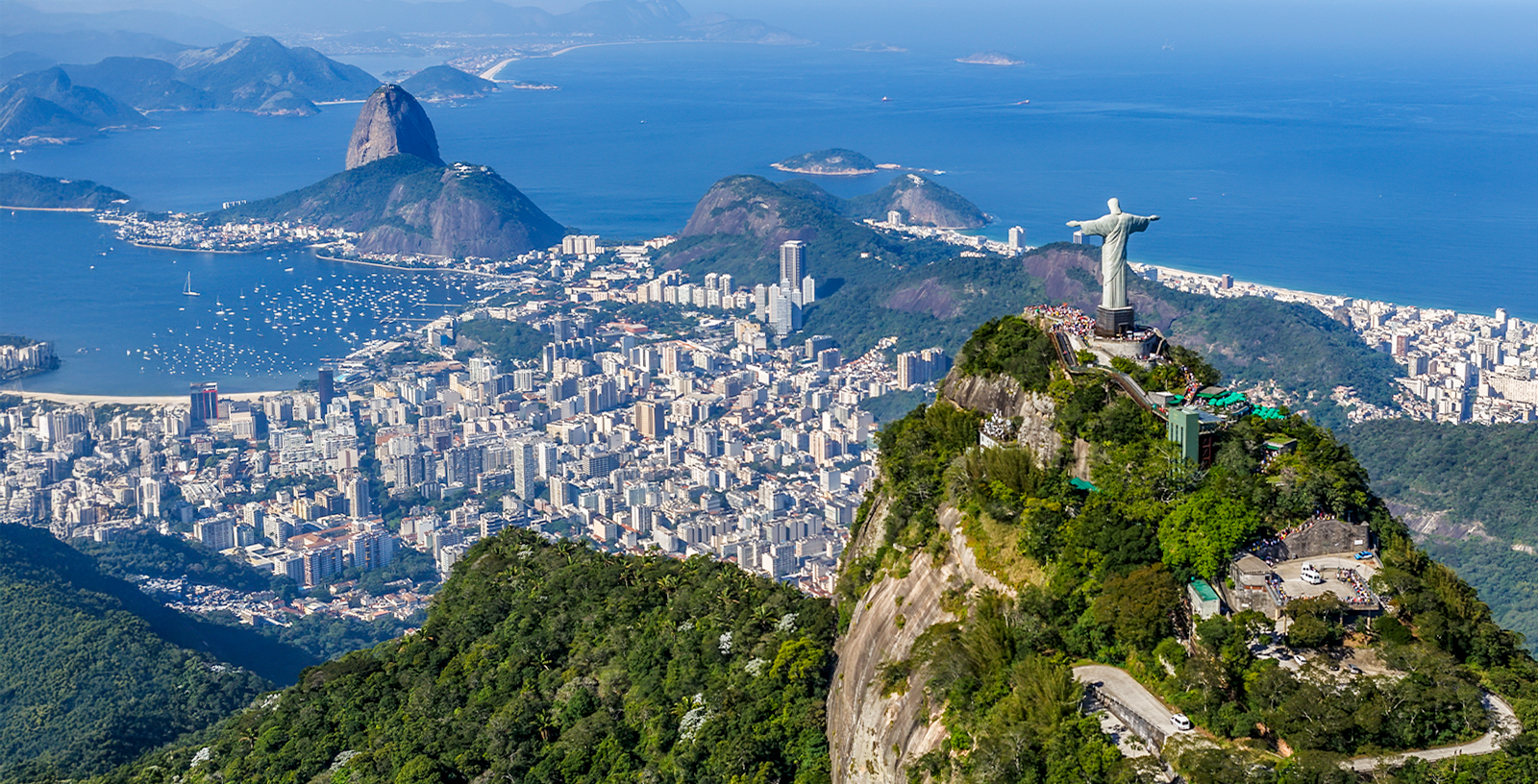 Christ the Redeemer overlooking Rio de Janeiro with Sugarloaf Mountain in the background.