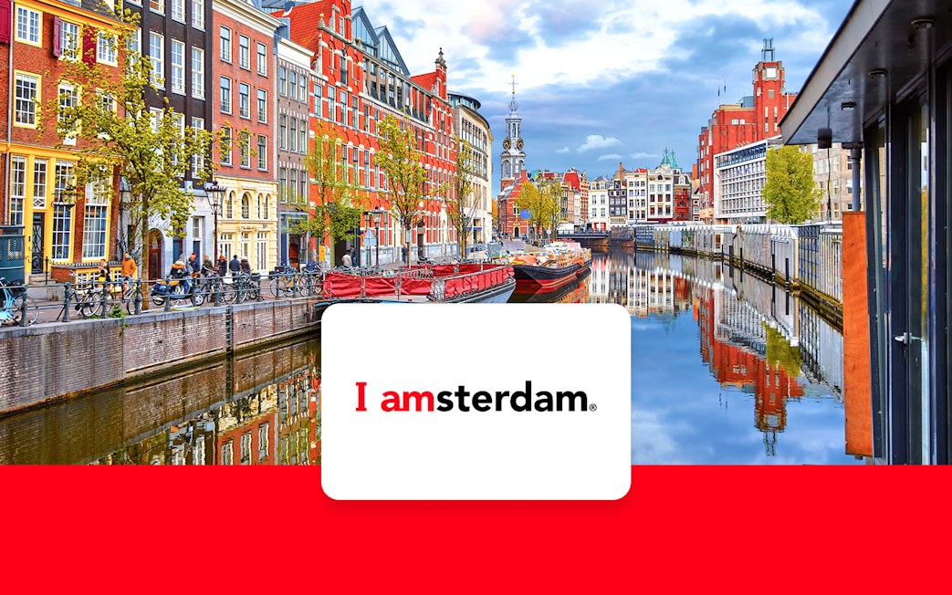Amsterdam canal view with historic buildings and bicycles, promoting I Amsterdam City Card.