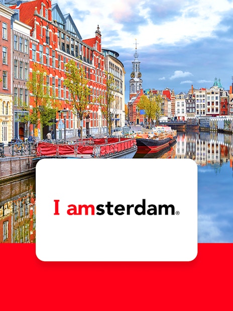 Amsterdam canal view with historic buildings and bicycles, promoting I Amsterdam City Card.