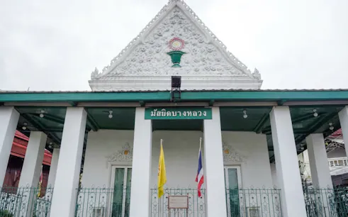 Bangkok mosque entrance with decorative facade and flags, part of Hidden Bangkok tour.