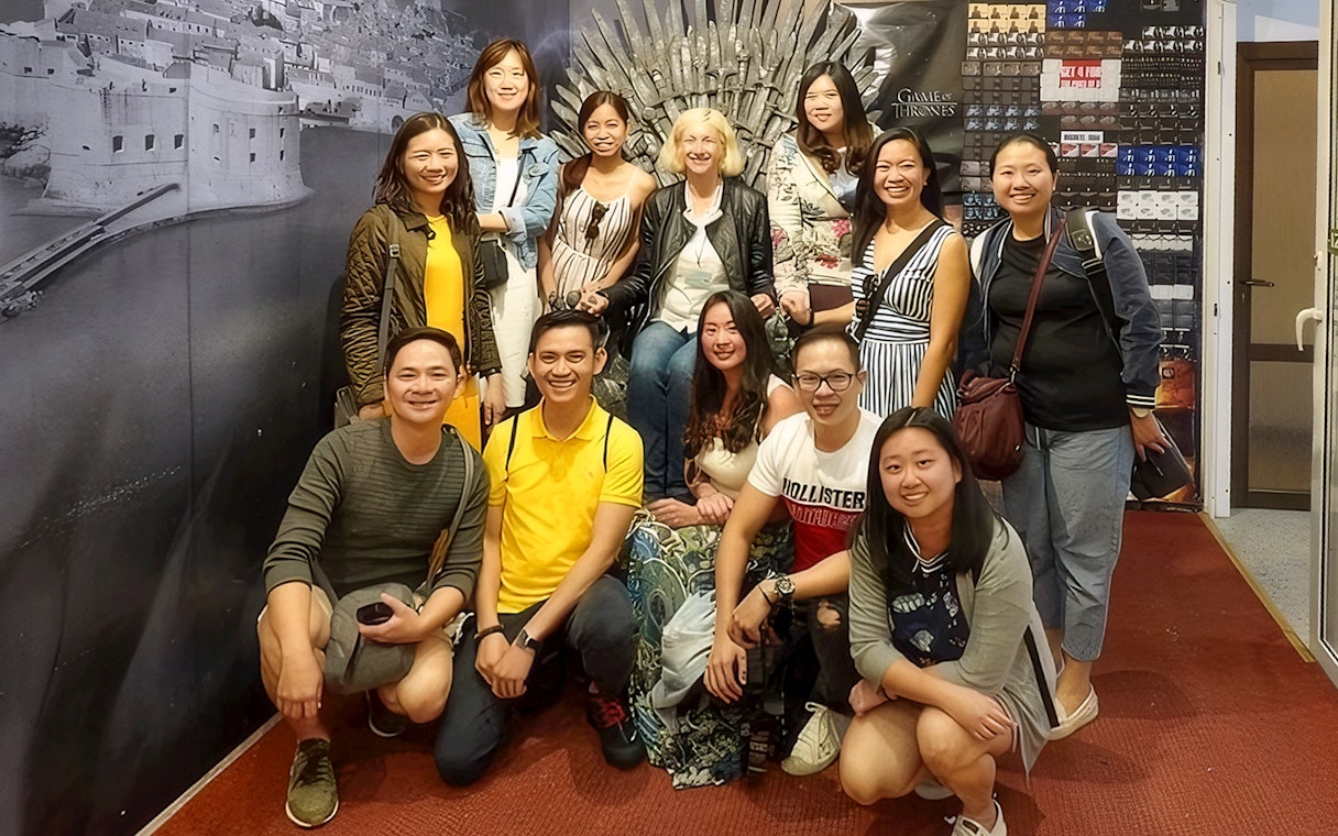 Guests pose with the Game of Thrones chair backdrop.