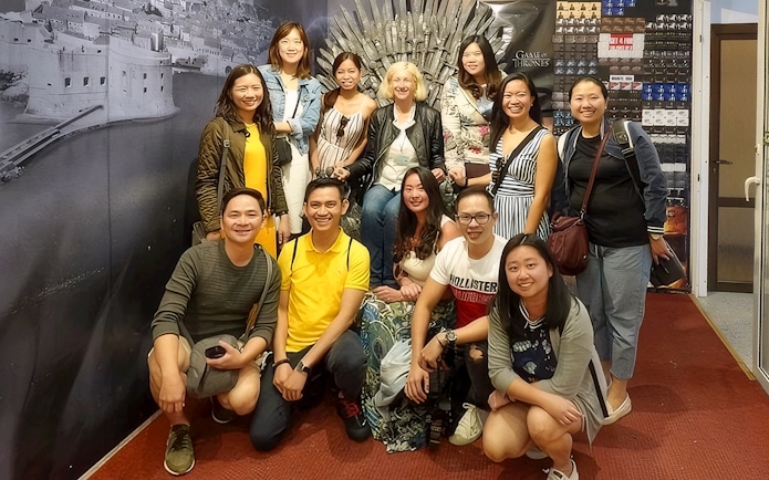 Guests pose with the Game of Thrones chair backdrop.