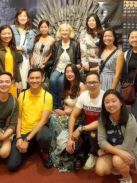 Guests pose with the Game of Thrones chair backdrop.
